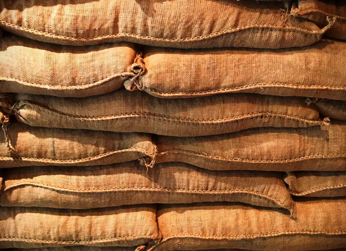 Stacked jute sacks of agricultural produce in a warehouse